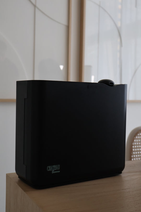 Chateau Grande Scent Diffuser in black finish on modern wooden table – premium cold-air scent diffuser by Chateau Essence